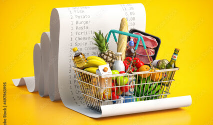 Shopping basket with foods on receipt. Grocery  expenses budget, inflation and consumerism concept.